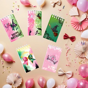 Close-up of five spiral notebooks with witch-themed happy birthday party designs