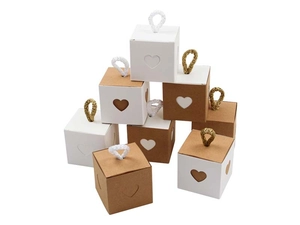 Detail of kraft paper gift boxes with heart-shaped cutout and woven handles for weddings