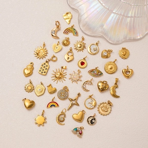 Golden bohemian celestial charms set featuring sun moon and star motifs on beige background