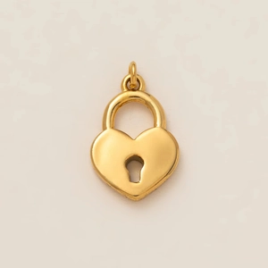 Detailed view of polished gold heart lock charm with keyhole and link connector