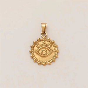 Macro detail of 18k gold plated sun and evil eye coin pendant with embossed texture