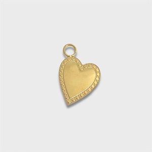 Close-up of golden heart pendant featuring dotted relief texture and secure top loop