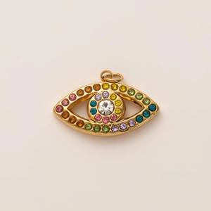 Macro view of gold-plated evil eye pendant with vibrant multicolored rhinestones