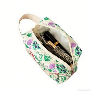Borsa da trucco trapuntata con motivo floreale viola e manico superiore per cosmetici