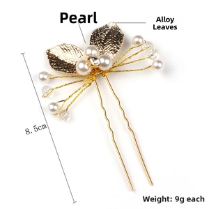 Detailed close-up of golden U-shaped hair pin with alloy leaves, pearls, and crystals