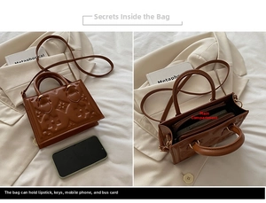 Detailed view showing the embossed leather texture and spacious interior of the brown retro bag