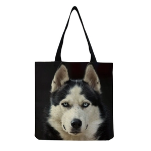 Close-up of a black canvas tote bag featuring a realistic Siberian Husky dog portrait
