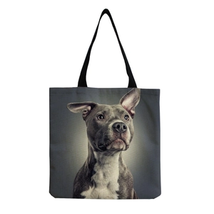 Close-up of a canvas tote bag featuring a high-definition grey pit bull dog art print