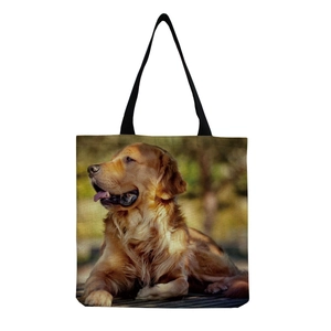 Detail of canvas tote bag featuring a realistic golden retriever dog print and black handles