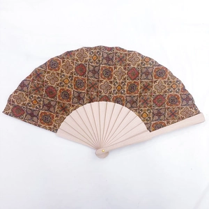 Detail of vintage cork folding fan with geometric pattern and natural wood ribs