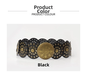 Detail of vintage bohemian belt with black round discs and antique bronze floral engraving