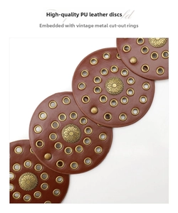 Detailed view of vintage brown PU leather circles with gold eyelets and floral metal studs