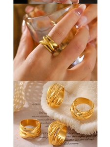 Detail of 18k gold plated titanium steel rings with intertwined lines and wide band