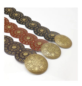 Detailed view of Western-style bohemian belts with vintage sunflower embossed metal buckles