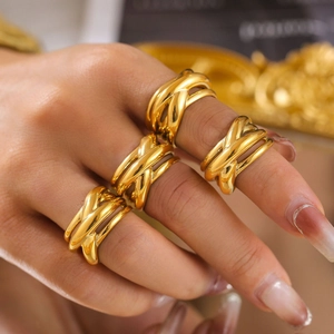 Four-piece set of gold titanium steel rings with layered crisscross geometric design