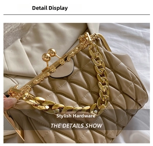 Close-up of golden hollowed frame lock and pearl clasp on quilted leather handbag
