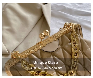 Detail of vintage kiss-lock closure and gold engraved hardware on beige quilted bag
