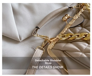 Close-up of golden hardware details and detachable strap on quilted leather handbag