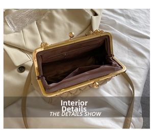 Detail shot of beige cloud bag interior with brown lining, zipper pocket and metal clasp