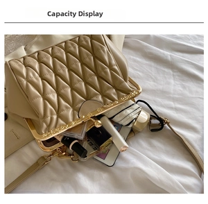 Interior capacity show of quilted shell handbag with phone and cosmetics storage space