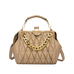 Khaki quilted crossbody bag with gold chain and vintage frame closure on white backdrop