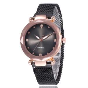 Detail of rose gold quartz watch with faceted glass and black Milanese mesh strap