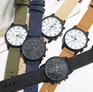 Multiple quartz watches with colorful canvas straps displayed on a clean white surface