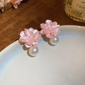 Detailed close-up showing pink resin petal flower earrings with white pearl drops