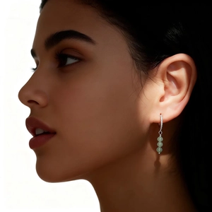 Detail of s925 silver hoop earrings with three light green aventurine stone beads
