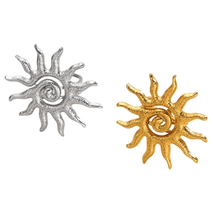 Detailed view of sun-shaped rings with spiral center in gold and silver finishes