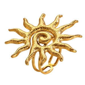 Detailed macro view of a gold sunburst ring with textured metal sunrays and open band
