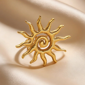 Detail shot of a golden sun ring with a spiral center and vintage frosted texture
