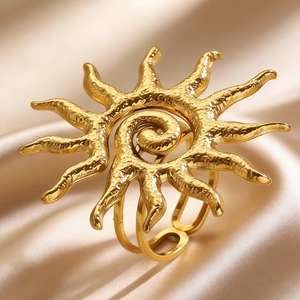 Macro shot of gold sunbeam ring with spiral center on luxury silk background