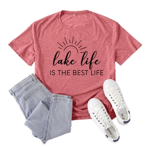 Women's red Lake Life graphic tee paired with blue jeans and white canvas shoes