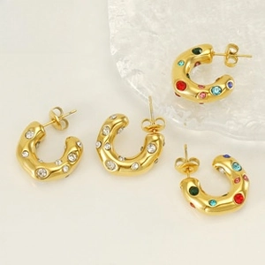 Detailed view of gold C-shaped earrings with textured finish and colorful zircon stones