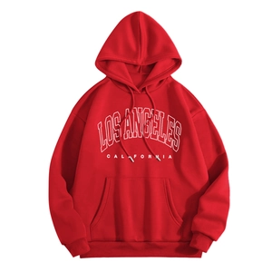 Detail of red hoodie with white Los Angeles print and kangaroo pocket texture
