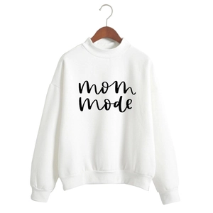 Detail of mom mode lettering on a white crewneck sweatshirt with ribbed cuffs