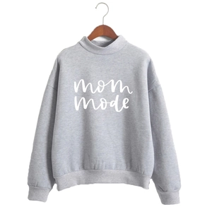 Close-up of MOM MODE white lettering on gray high neck long sleeve sweatshirt