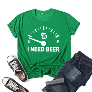 Detailed flat lay of green I Need Beer t-shirt with cotton texture and creative print