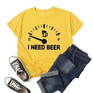Flat lay of yellow 'I Need Beer' t-shirt paired with ripped jeans and casual sneakers
