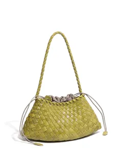 Green woven leather tote bag with French minimalist design and drawstring interior lining