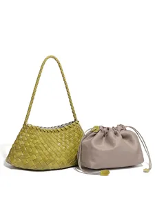 Olive green hand-woven leather tote with a beige drawstring inner pouch and shoulder strap