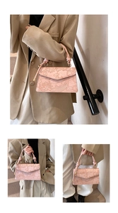 Detailed relief texture on pink handbag featuring lotus and koi fish embossed art