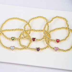 Set of six gold beaded heart bracelets with colorful birthstone charms for women