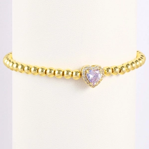 Gold-plated beaded bracelet featuring a heart pendant with a purple crystal birthstone
