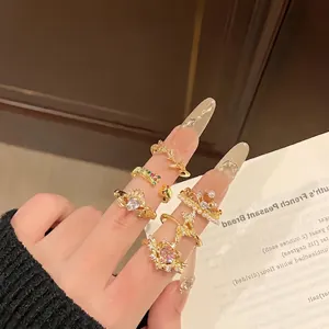 Elegant gold ring set with baroque heart and crown designs worn on model hands