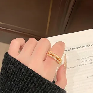 Elegant gold double-layer pavé crystal ring for women with minimalist wavy design