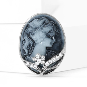 Detail of vintage cameo brooch featuring blue lady relief and sparkling crystal accents