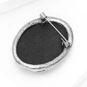 Macro view of vintage oval brooch back with silver metal frame and secure pin closure