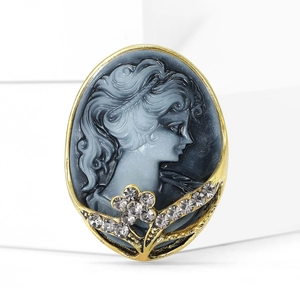 Macro detail of vintage relief lady cameo brooch with sparkling crystal floral accents